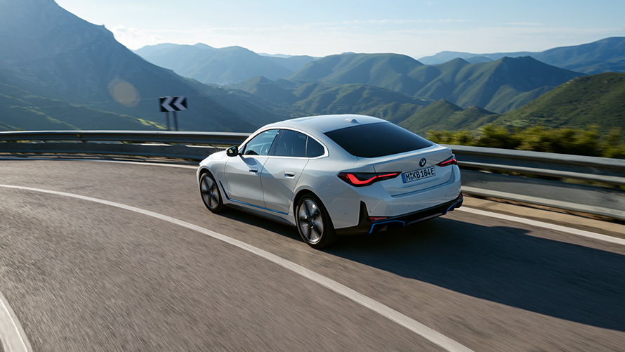 BMW Special Sales Sustainability Hub Overview Fleet Data BMW vehicle driving on road in front of mountain scenery