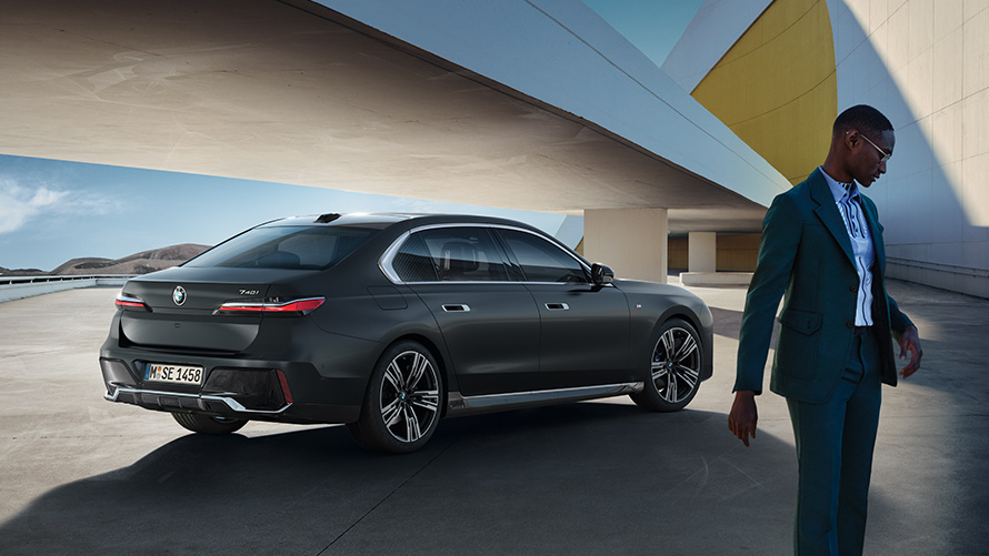 BMW Diplomatic Sales benefits for diplomats Man standing in front of his BMW diplomatic vehicle 